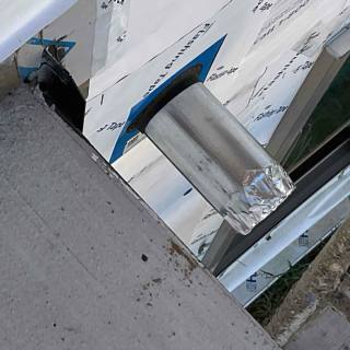 Site photo: unsealed pipe penetration through wrap