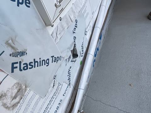 Site photo: flashing tape at the base of a wall